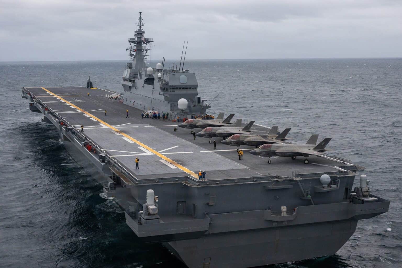 JS Kaga deck lined with F-35B fighters seen from astern