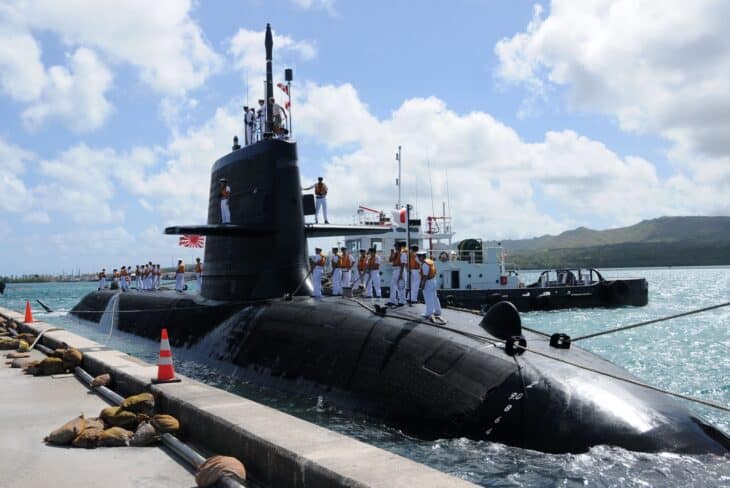 Soryu-class submarine JS Hakuryu alongside a pier with crew on deck