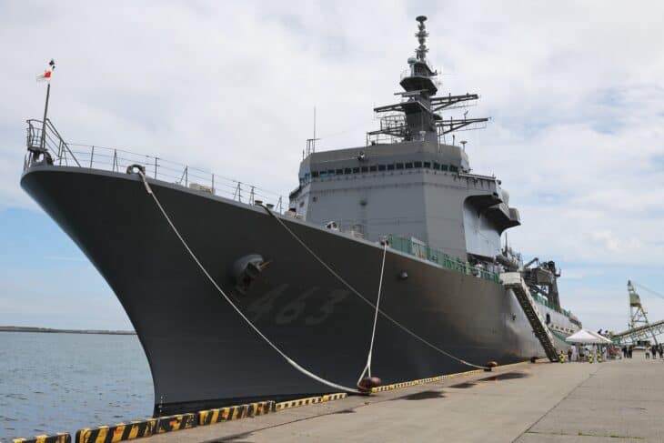 Bow of a JMSDF Uraga-class minesweeper tender alongside a pier