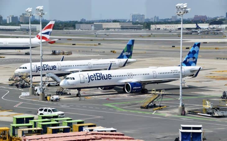 Two JetBlue Airbus A321s parked at a gate at New York JFK