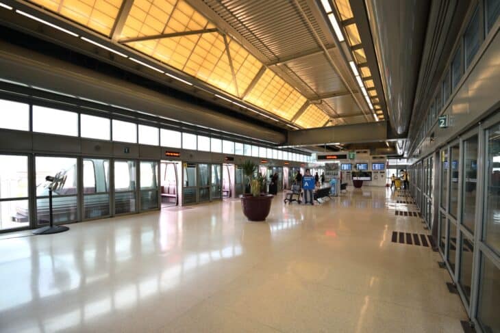Newark Terminal A AirTrain station concourse with a bright ceiling