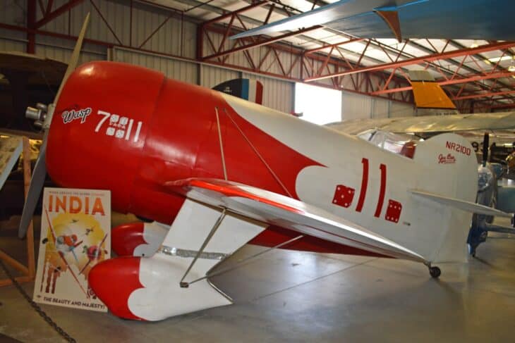 Red and white Granville Gee Bee R-1 replica on display in a museum hangar