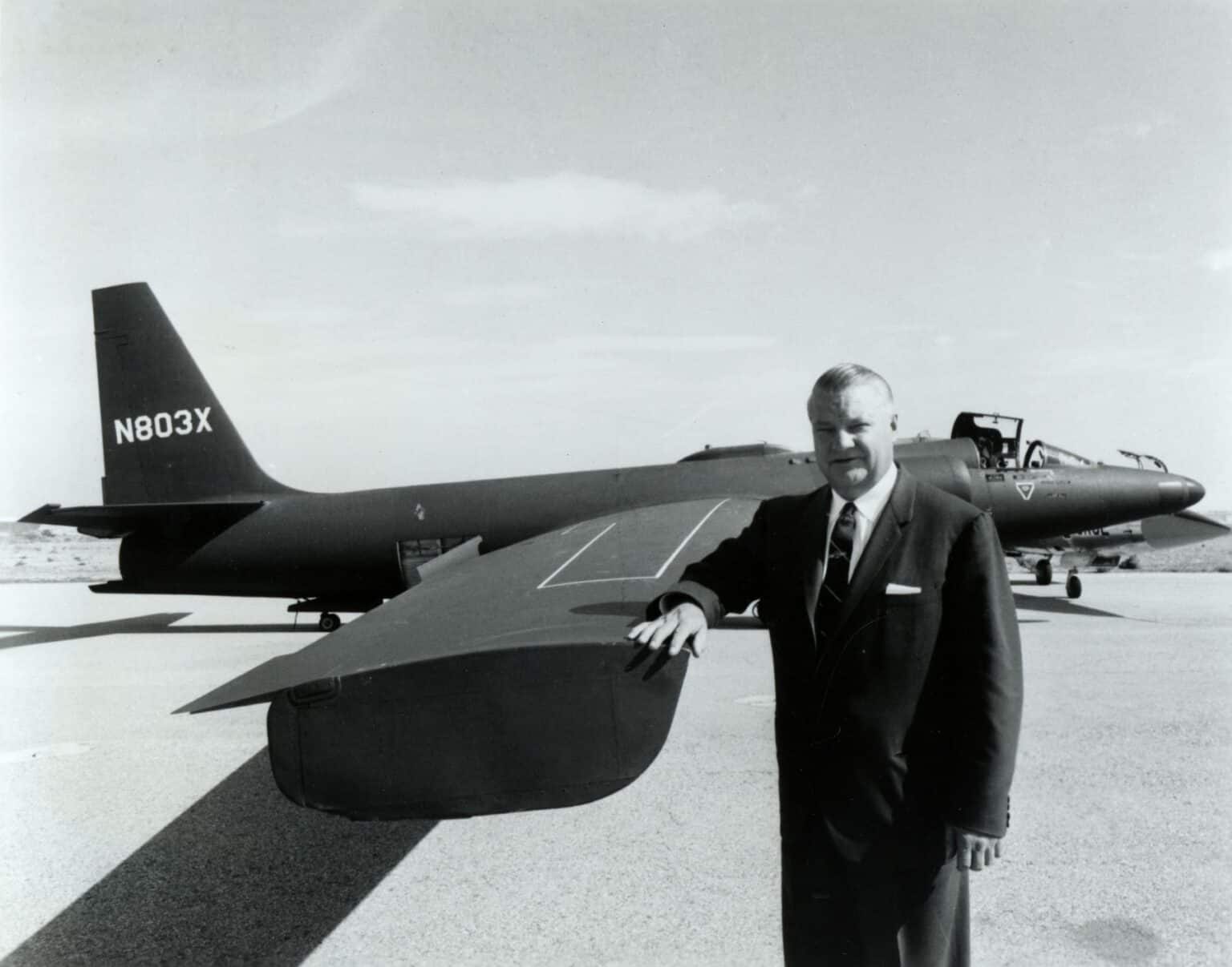 Kelly Johnson, Lockheed's chief designer, standing beside the nose of a U-2 at the dry lake test site in a black-and-white US Air Force photo