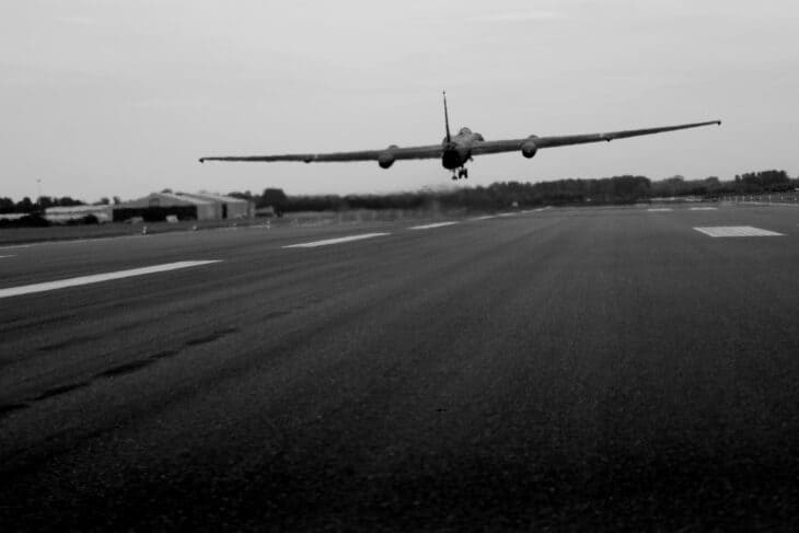 Lockheed U-2 lifting off a runway in a low-angle black-and-white frame