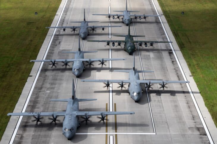 Six C-130 transports lined up on the runway at Andersen Air Force Base during Operation Christmas Drop