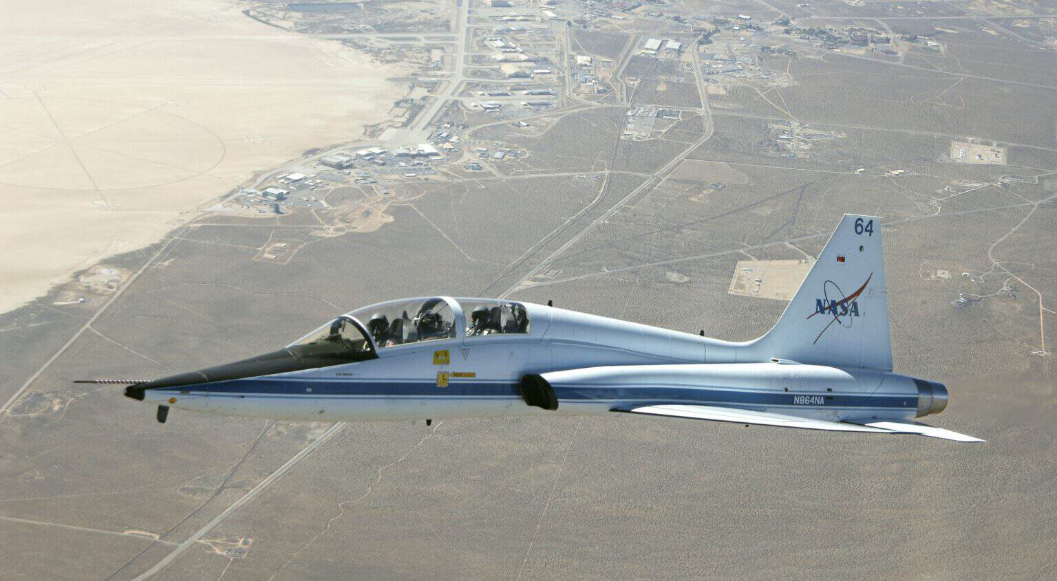 NASA T-38 Talon in flight over the main base complex at Edwards Air Force Base and Rogers Dry Lake