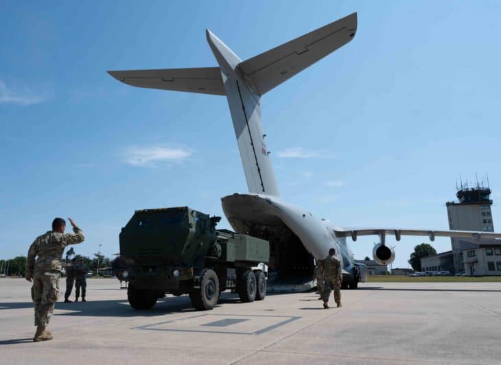 HIMARS rocket launcher driving out of a Portuguese KC-390 transport on the ramp at Ramstein Air Base