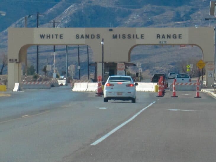 Entrance gate of White Sands Missile Range with the sign arching over the road