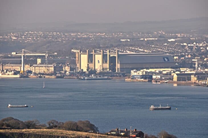 Devonport naval dockyard and its covered docks seen across the River Tamar from Cornwall
