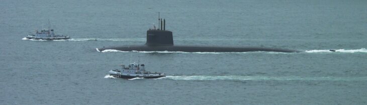 French Triomphant-class submarine Le Terrible escorted by tugs on the surface
