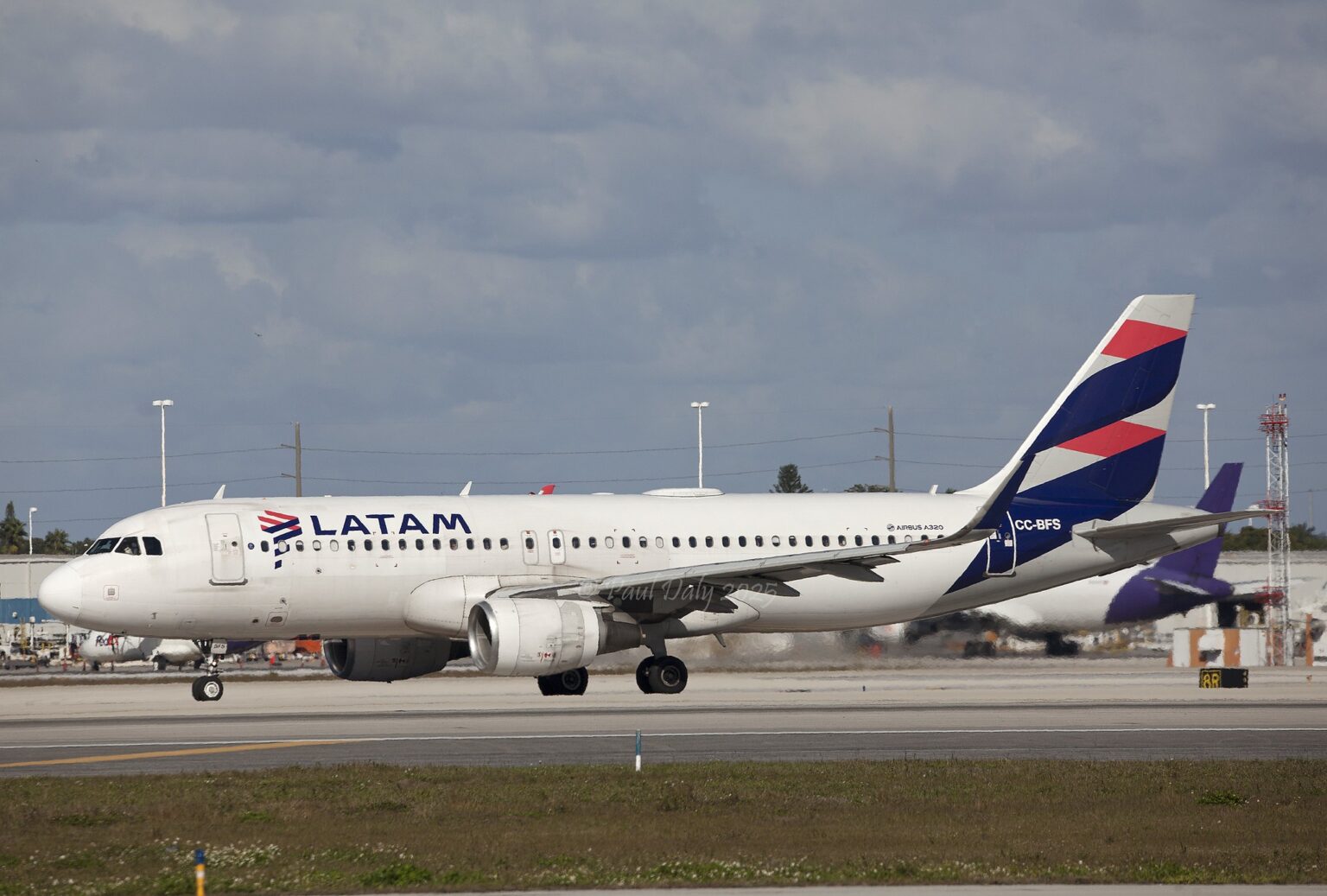 LATAM Airbus A320 CC-BFS rolling along a runway, registration visible on the tail