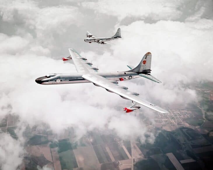 Convair NB-36H nuclear test aircraft in flight above clouds with a B-50 chase plane behind it