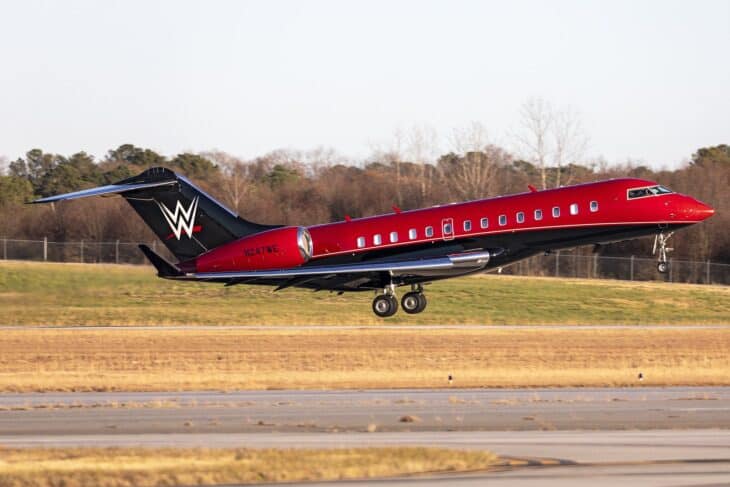 WWE Bombardier Global 5000 N247WE in red and black livery landing on a runway