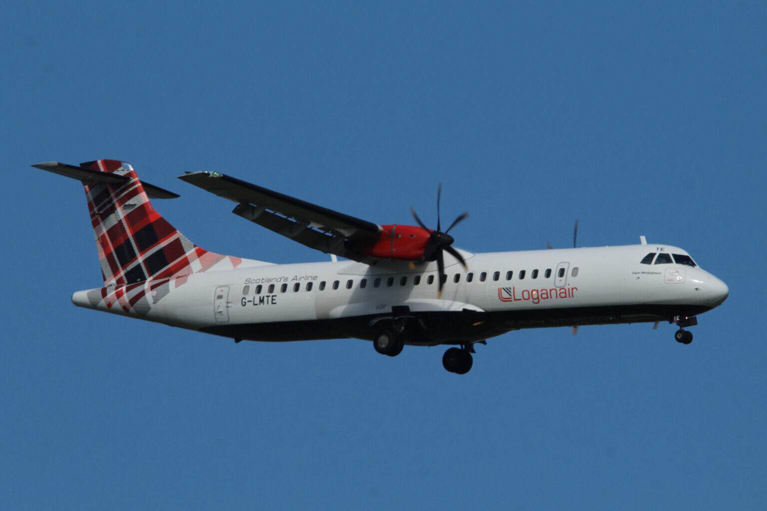 Loganair ATR 72-600 G-LMTE in tartan livery on approach with landing gear down against a blue sky
