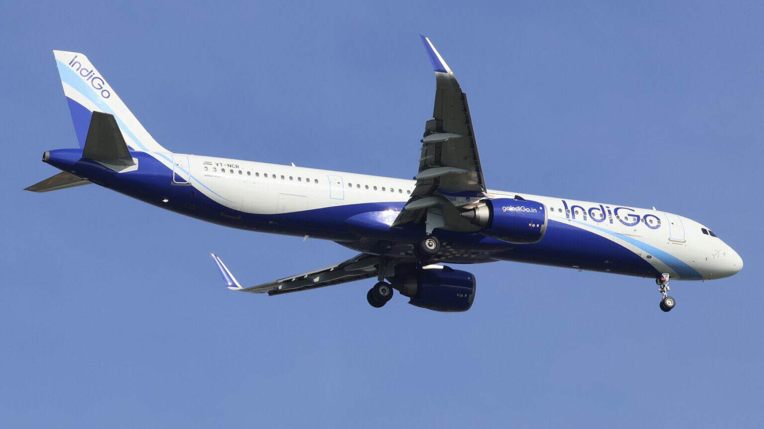 IndiGo Airbus A321neo-family jet VT-NCR banking in flight over Singapore