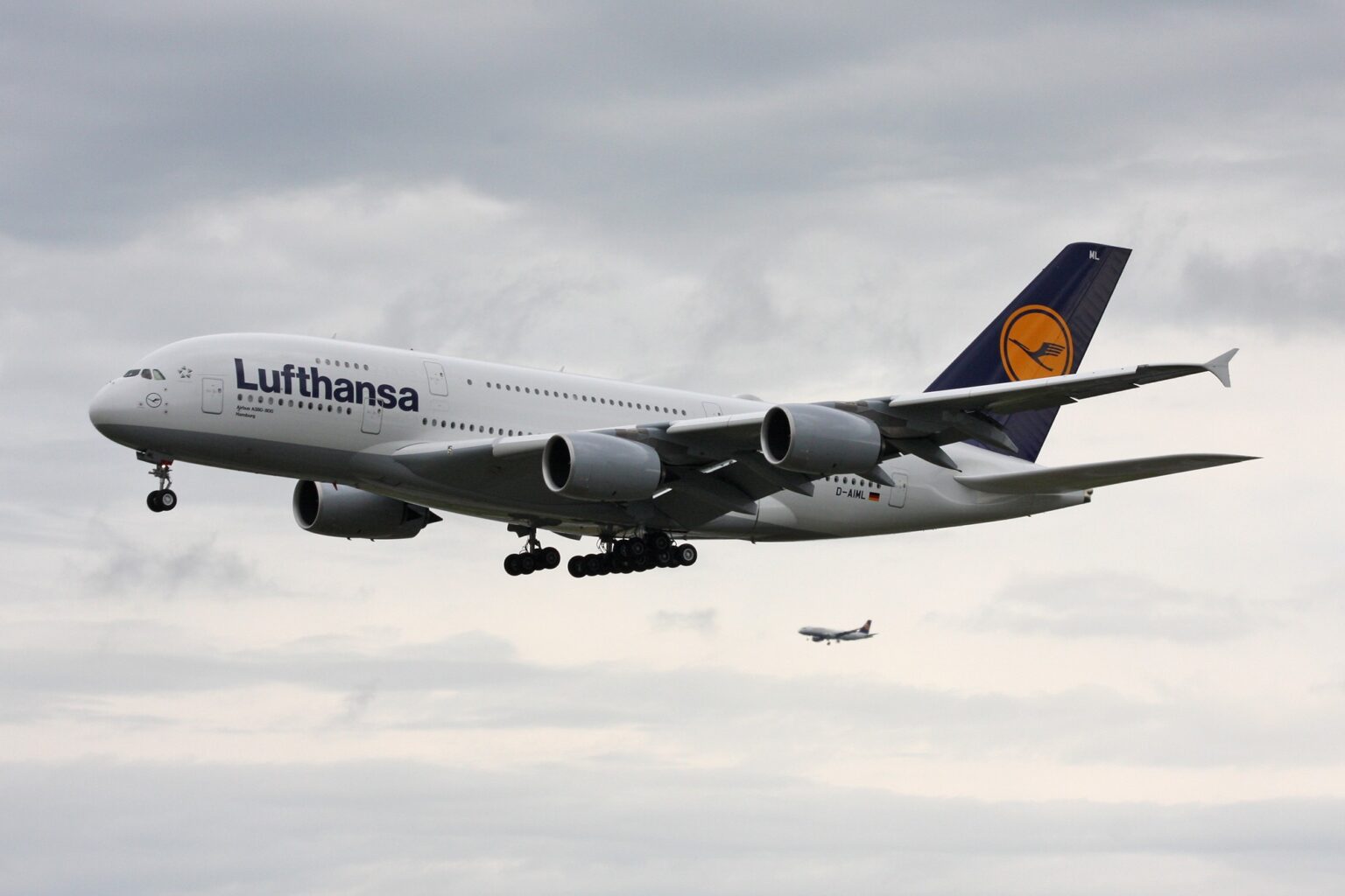 Lufthansa Airbus A380 D-AIML on final approach under an overcast sky with landing gear down