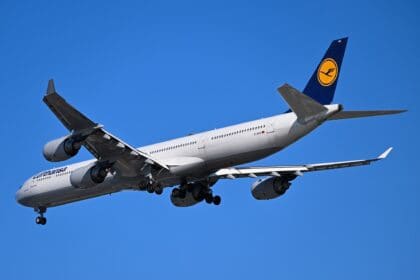 Lufthansa Airbus A340-600 D-AIHX on final approach to Boston with landing gear down against a blue sky