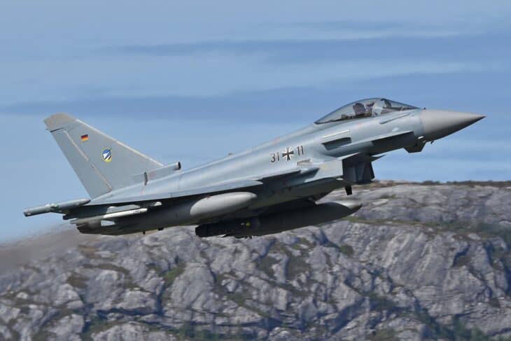 German Air Force Eurofighter Typhoon 31+11 climbing away after takeoff past rocky hills