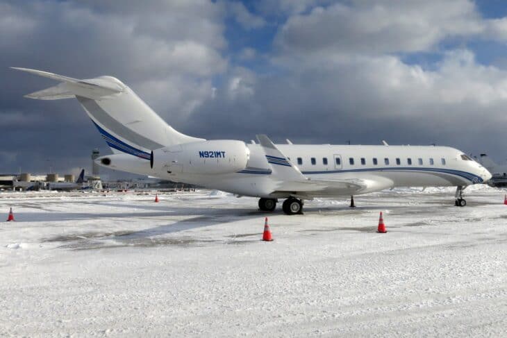 Bombardier Global 6000 N921MT parked on a snow-covered ramp at Cleveland