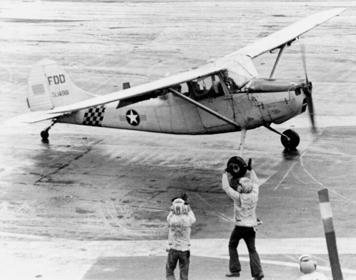 Major Buang's Cessna O-1 Bird Dog taxiing to a halt on the flight deck of USS Midway on April 29, 1975