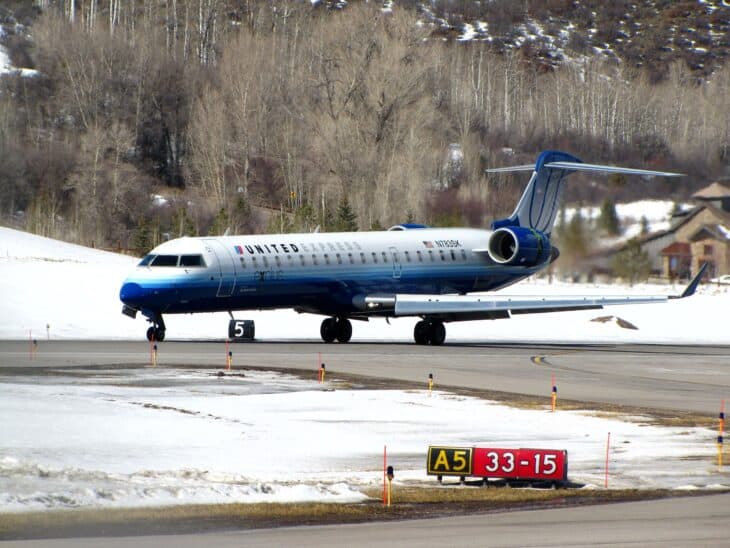 SkyWest Bombardier CRJ700 N783SK in United Express livery on the snowy ramp at Aspen airport