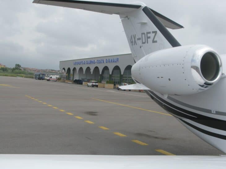 Salerno Costa d'Amalfi airport terminal seen past the tail of a parked business jet