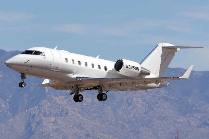 Bombardier Challenger 605 N3250N on approach with gear down over mountains