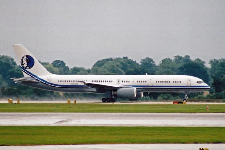 Boeing 757-200 N801DM with the Dallas Mavericks logo on its tail taxiing at Manchester