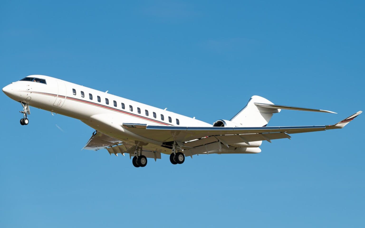 NetJets Bombardier Global 7500 N182QS climbing out after takeoff with gear retracting