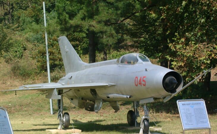 Shenyang J-7 fighter, the Chinese-built MiG-21, parked on grass with the number 045