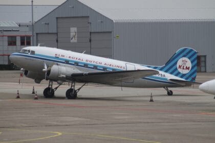 Vintage KLM Douglas DC-3 PH-PBA in the airline's retro blue-striped livery parked at Schiphol
