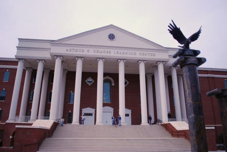 Columned brick building with an eagle statue on its roof at Liberty University