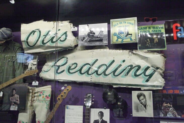 Pieces of Otis Redding's airplane with his name in script on display in the Rock and Roll Hall of Fame