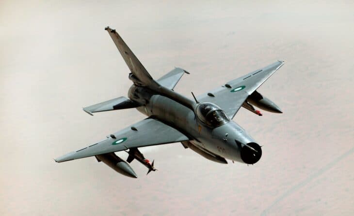 Pakistan Air Force Chengdu F-7 fighter banking over desert terrain