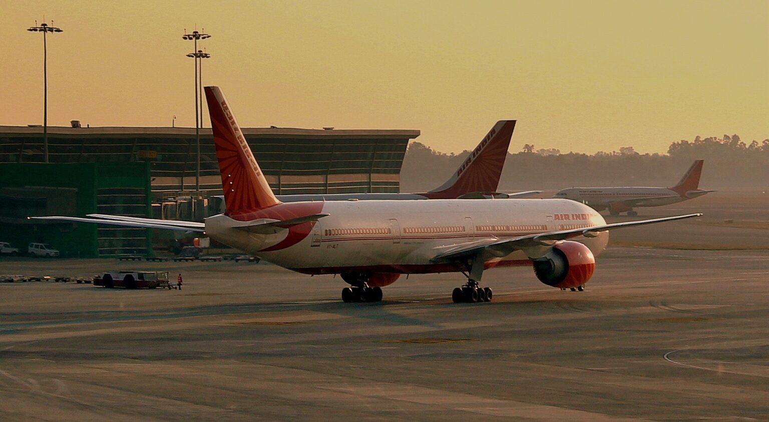 Air India Boeing 777-300ER taxiing at Delhi's Indira Gandhi International Airport at sunset