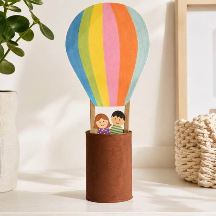 A cardboard tube makes a basket sturdy enough to hold a toy passenger.