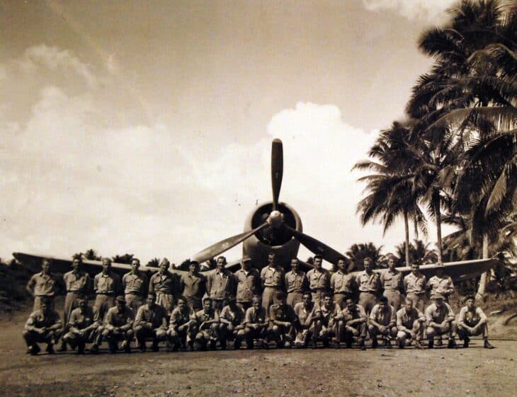 VMF-214 Black Sheep pilots posed in rows in front of a Vought F4U Corsair on the Turtle Bay fighter strip, Espiritu Santo