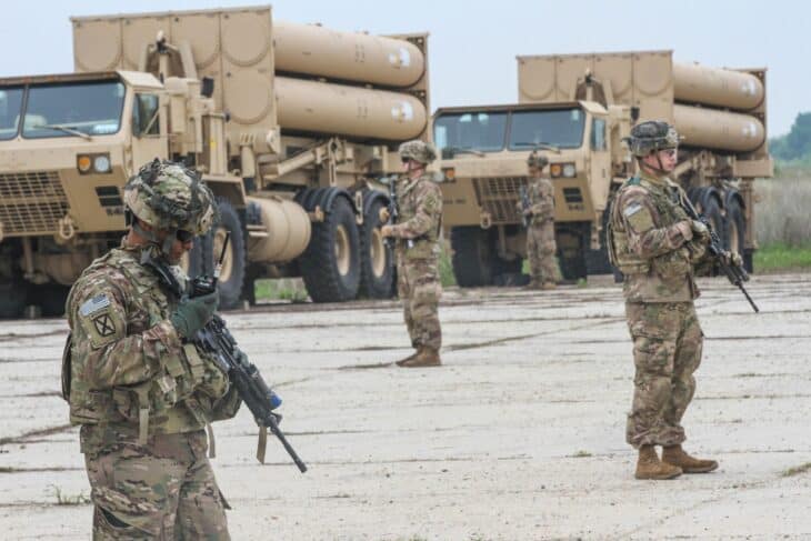 Soldiers guarding THAAD launcher trucks loaded with interceptor canisters during the first deployment to Romania