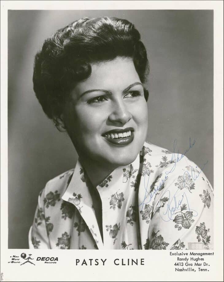 Black-and-white Decca Records publicity portrait of Patsy Cline, smiling in a floral blouse, 1960