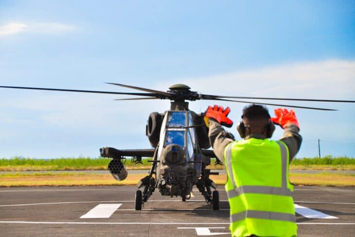 Philippine Air Force T129B ATAK attack helicopter facing the camera on the ramp as a ground crew member signals