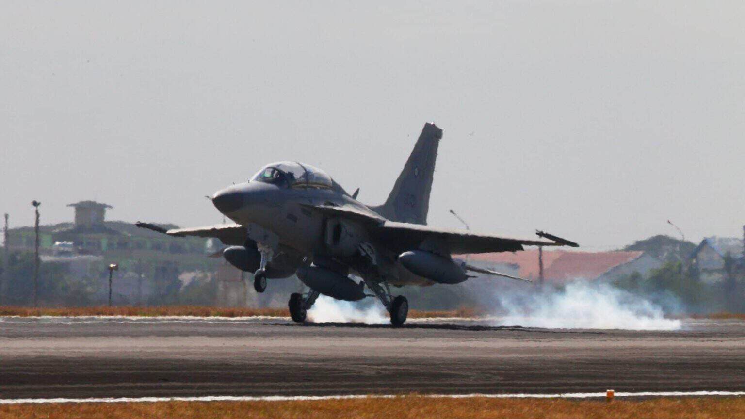 Philippine Air Force FA-50PH Fighting Eagle touching down with tire smoke streaming from the main gear