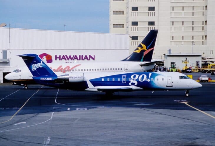 go! Bombardier CRJ200 N651BR on the ramp at Honolulu, with a Hawaiian aircraft behind it