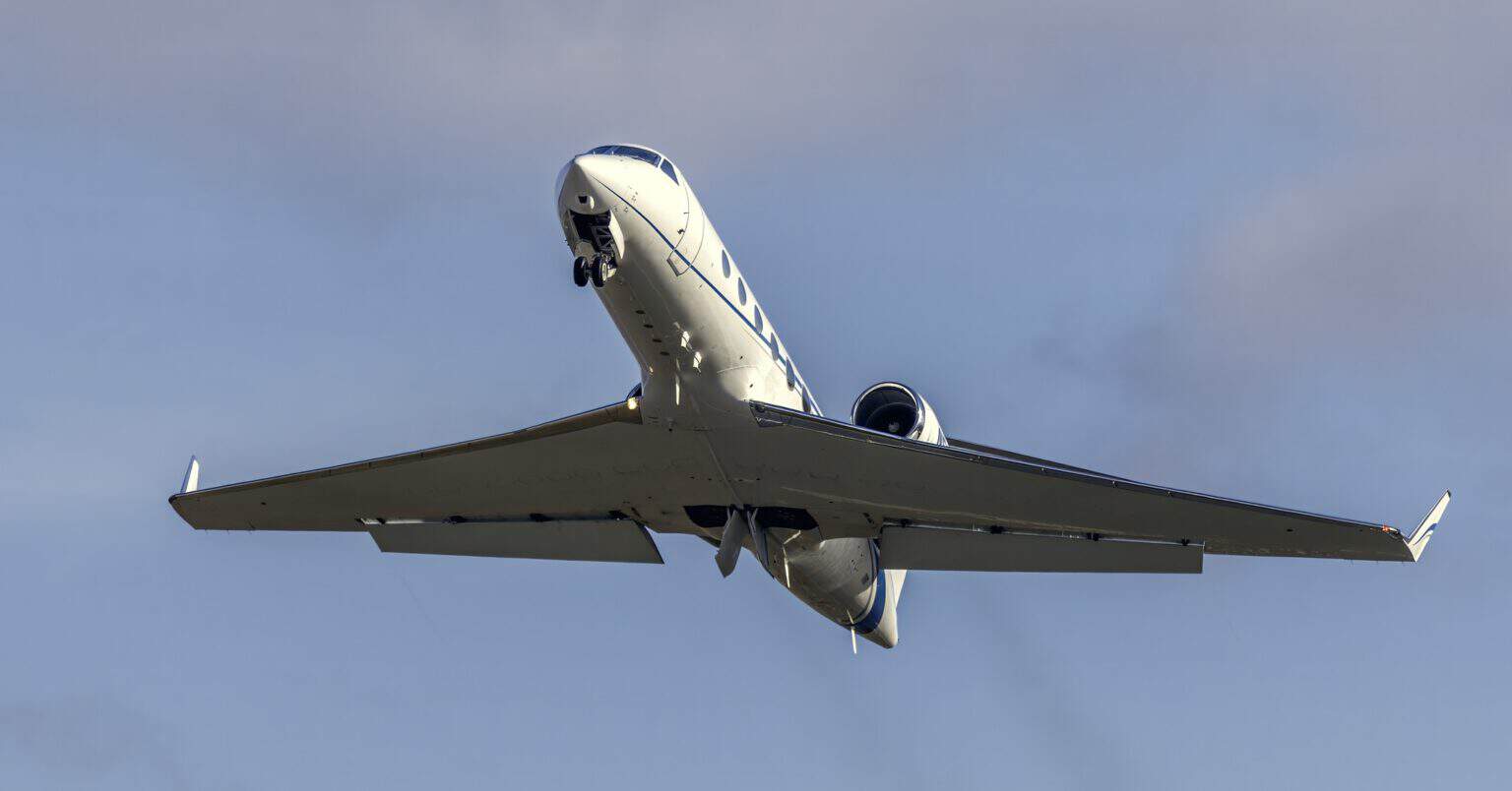 Gulfstream IV business jet seen from below in flight with its gear retracted