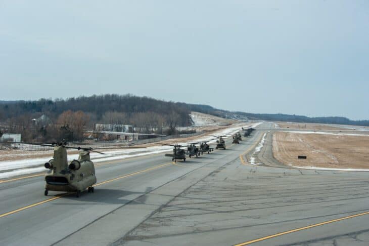Runway at Stewart International Airport with Army helicopters lined up before takeoff