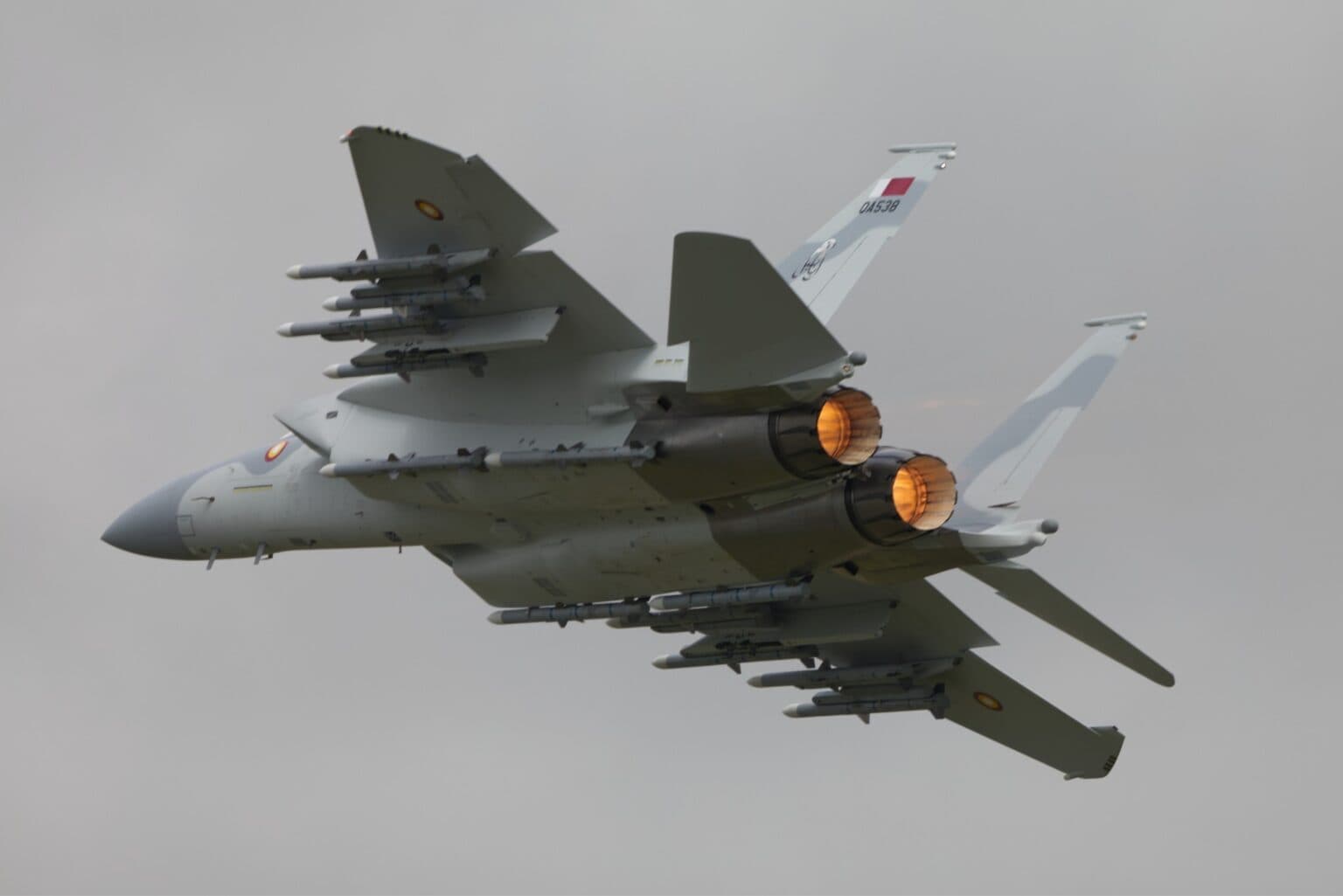 Qatar Emiri Air Force Boeing F-15QA Ababil climbing out with afterburners lit and weapons on its wing pylons