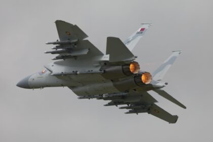 Qatar Emiri Air Force Boeing F-15QA Ababil climbing out with afterburners lit and weapons on its wing pylons