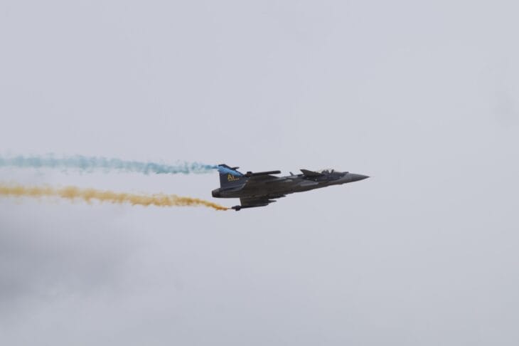Saab Gripen E flying with blue and yellow smoke trails at Flygdagarna 2026