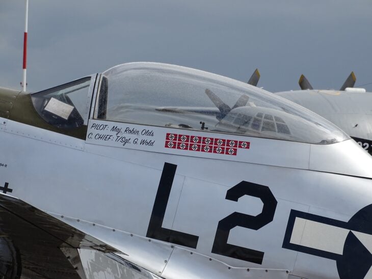 Cockpit area of a P-51D Mustang painted Scat with the name Maj Robin Olds stenciled on the canopy rail