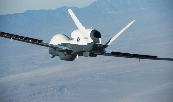 US Navy MQ-4C Triton in flight with long wings and a bulbous radome