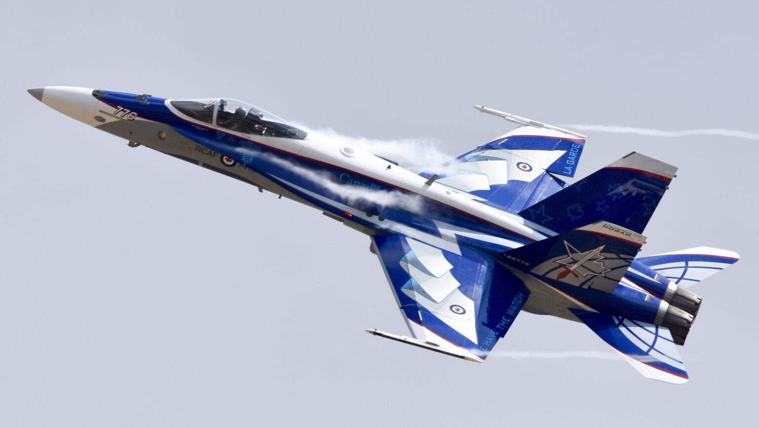 RCAF CF-188 Hornet in a blue demonstration scheme banking in flight
